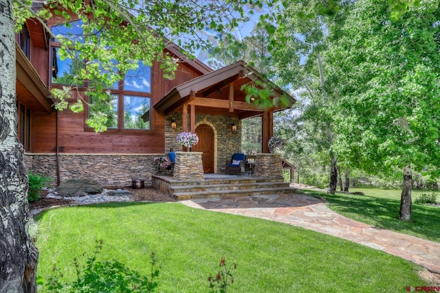 view of front of house with a patio and a front lawn