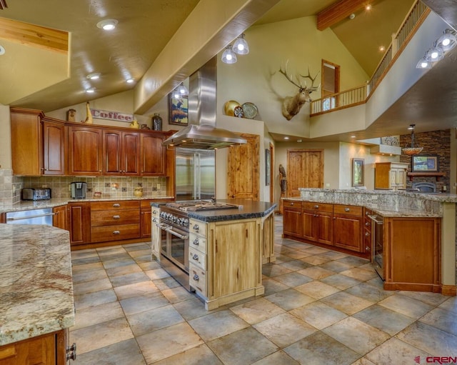 kitchen with appliances with stainless steel finishes, tasteful backsplash, island range hood, a kitchen island, and high vaulted ceiling