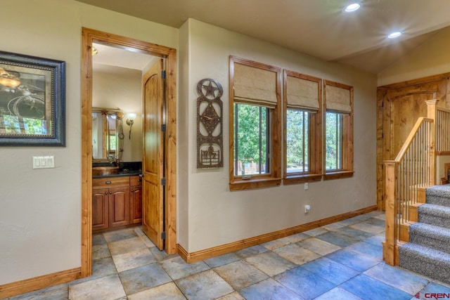 tiled entryway featuring vaulted ceiling