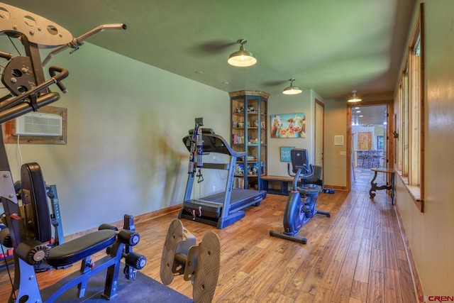 387 Bristlecone Dr, Pagosa Springs, CO 81147 - workout area featuring baseboards, hardwood / wood-style flooring, and an AC wall unit