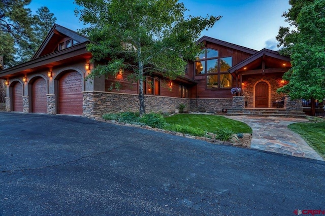 387 Bristlecone Dr, Pagosa Springs, CO 81147 - view of front facade featuring driveway, a garage, and stone siding