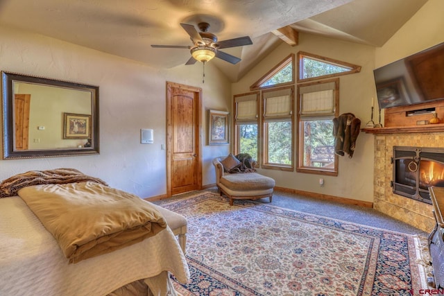 bedroom featuring a tile fireplace, ceiling fan, carpet flooring, and vaulted ceiling with beams