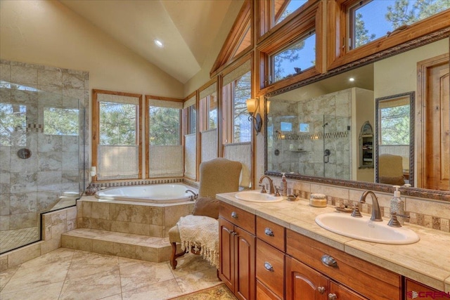 bathroom with backsplash, tile patterned floors, shower with separate bathtub, high vaulted ceiling, and double sink vanity