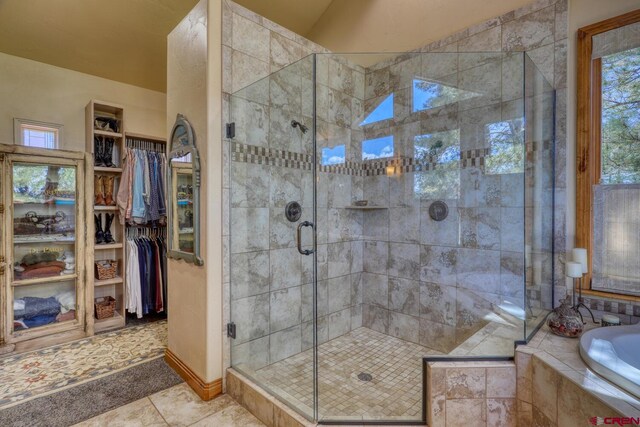 387 Bristlecone Dr, Pagosa Springs, CO 81147 - bathroom with a walk in closet, a stall shower, tile patterned flooring, and a bath
