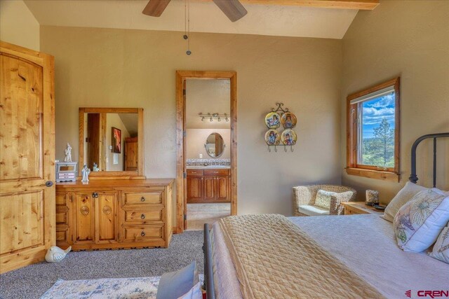 bedroom featuring lofted ceiling with beams, ensuite bathroom, light colored carpet, and ceiling fan