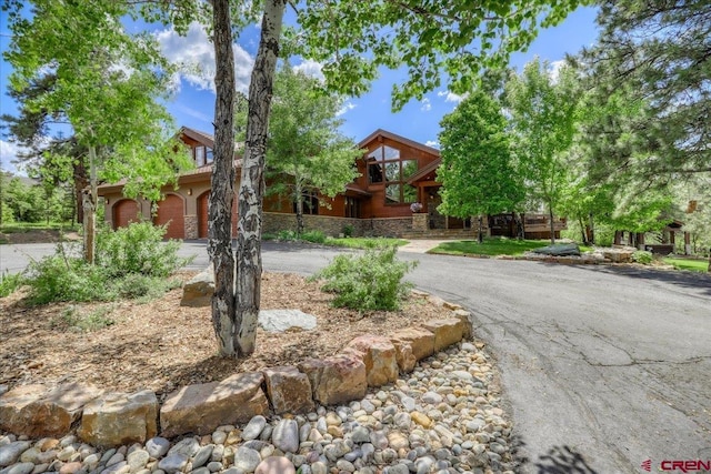 387 Bristlecone Dr, Pagosa Springs, CO 81147 - view of front facade with a garage and curved driveway