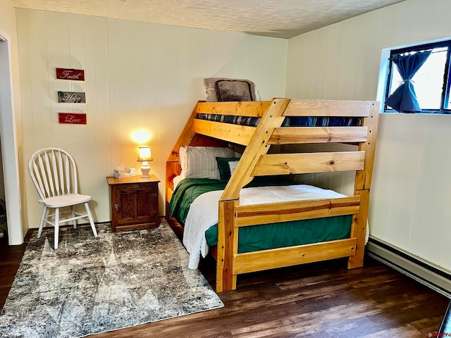 bedroom featuring a textured ceiling and hardwood / wood-style flooring