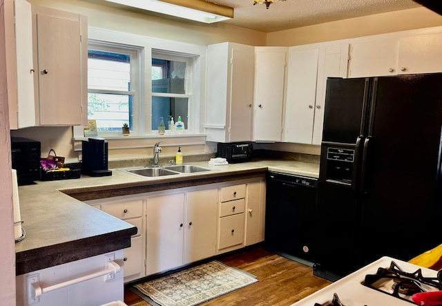 kitchen featuring black appliances, sink, white cabinets, and dark hardwood / wood-style floors