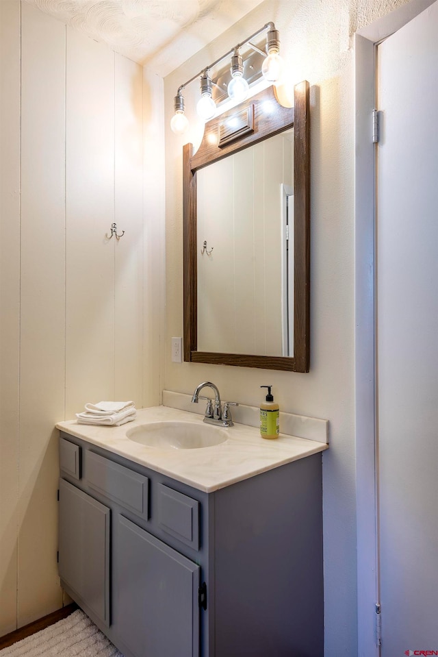 bathroom with a textured ceiling and vanity