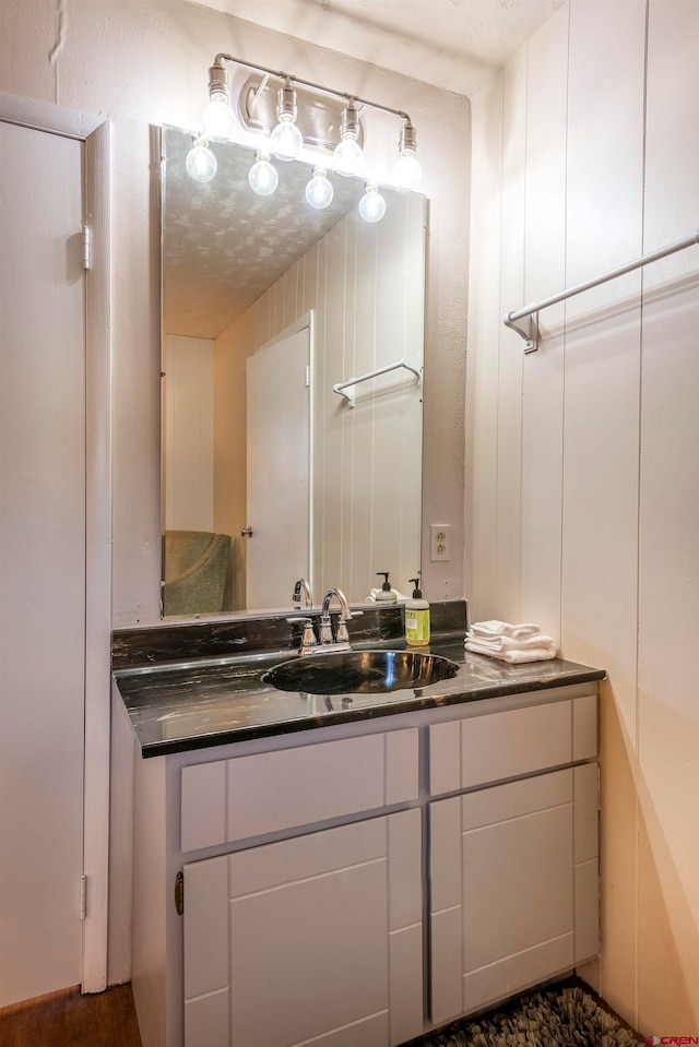 bathroom with a textured ceiling and vanity