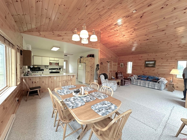 dining area featuring plenty of natural light, light colored carpet, wooden walls, and wooden ceiling