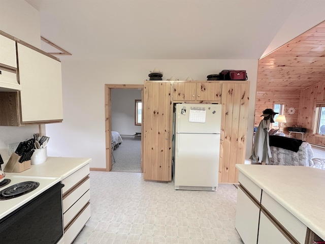 kitchen with custom range hood, wooden walls, white appliances, light colored carpet, and vaulted ceiling