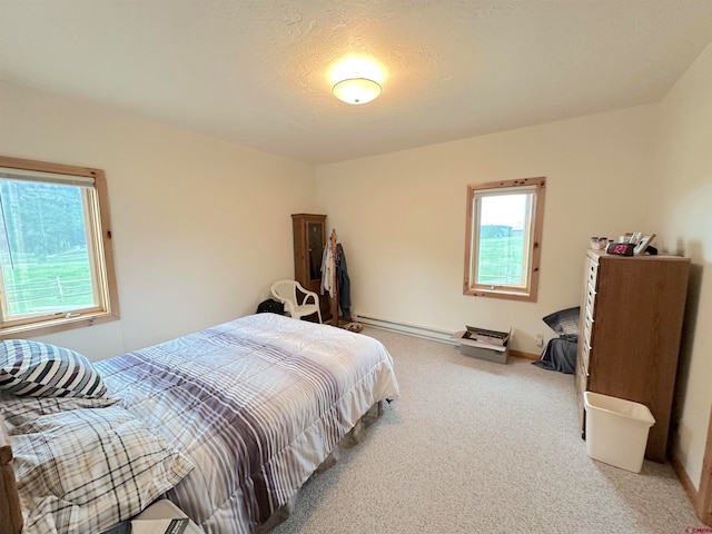 bedroom featuring carpet floors and a baseboard heating unit