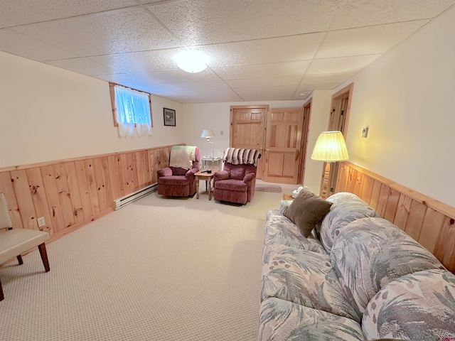 carpeted living room with a baseboard radiator and a drop ceiling