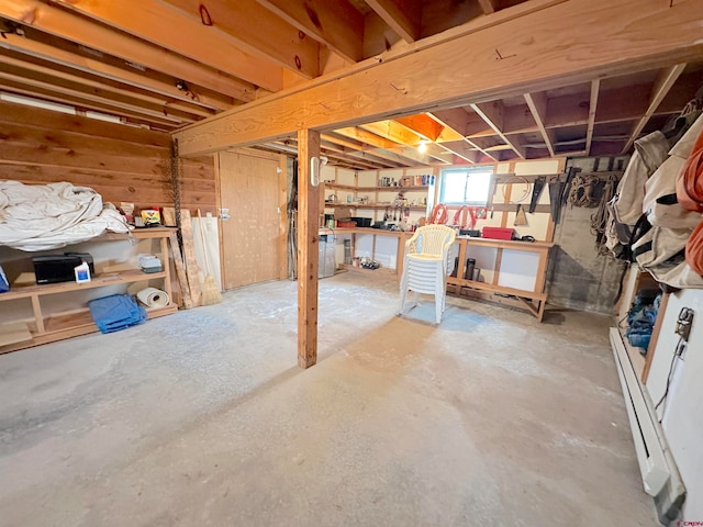 basement with a workshop area and a baseboard radiator