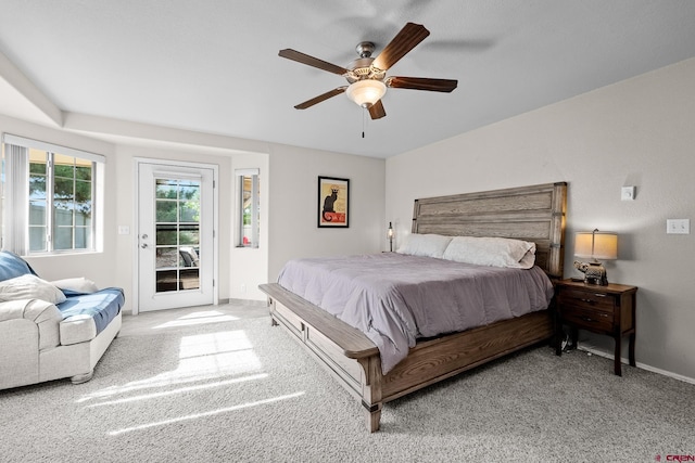 carpeted bedroom with a ceiling fan, access to outside, and baseboards