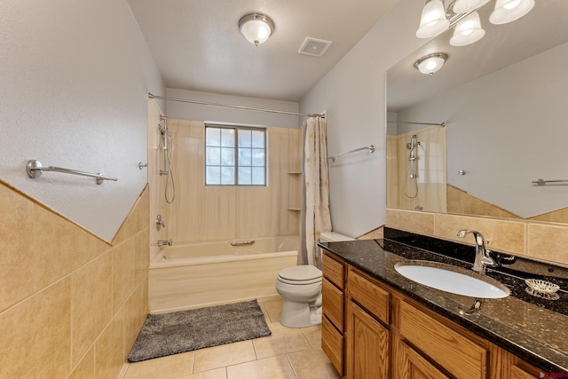 full bath featuring toilet, shower / tub combo, vanity, visible vents, and tile patterned floors