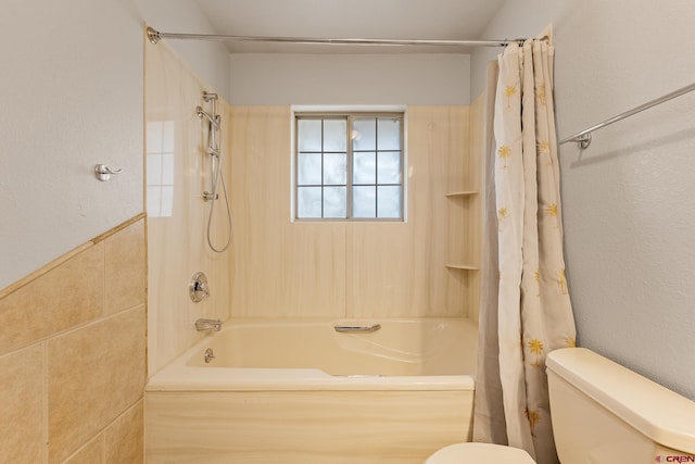 full bath featuring toilet, tile walls, and shower / bath combination with curtain