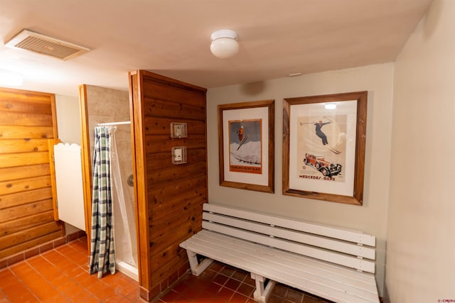 corridor with radiator and tile patterned floors