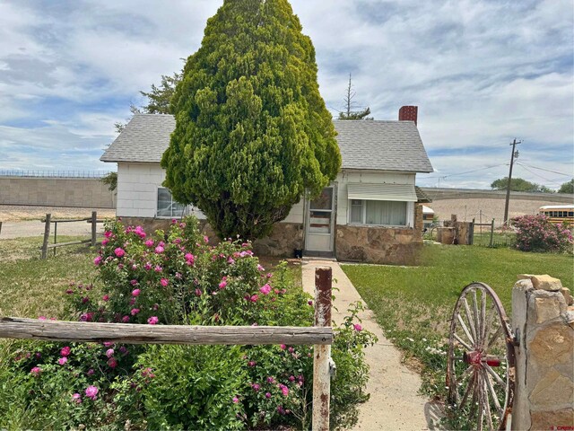 view of side of home with a yard