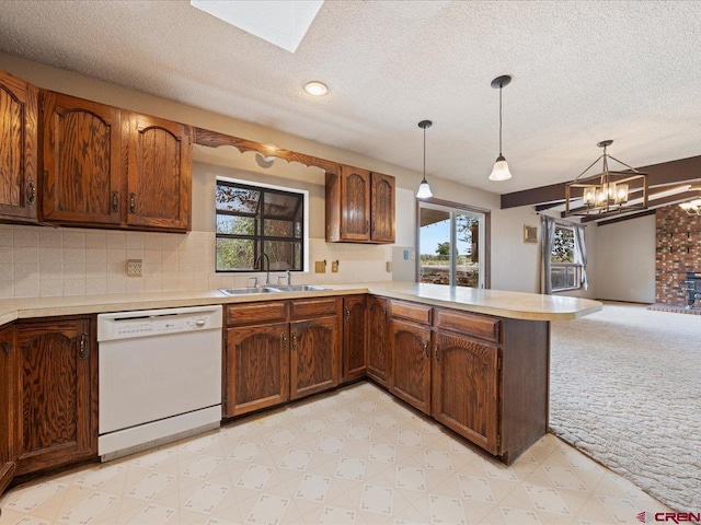 kitchen featuring light carpet, plenty of natural light, sink, and dishwasher