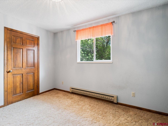 unfurnished bedroom featuring a textured ceiling, carpet, and a baseboard heating unit