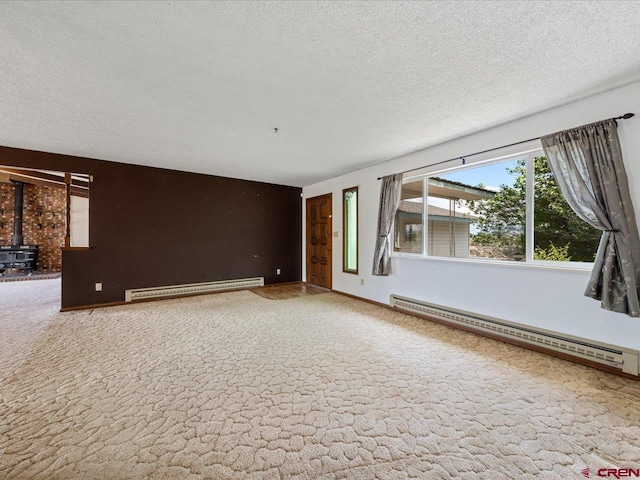 unfurnished living room featuring light carpet, a wood stove, and a baseboard radiator