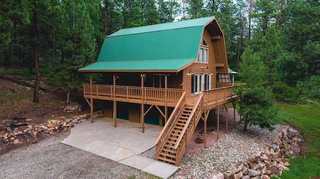 rear view of property featuring a deck