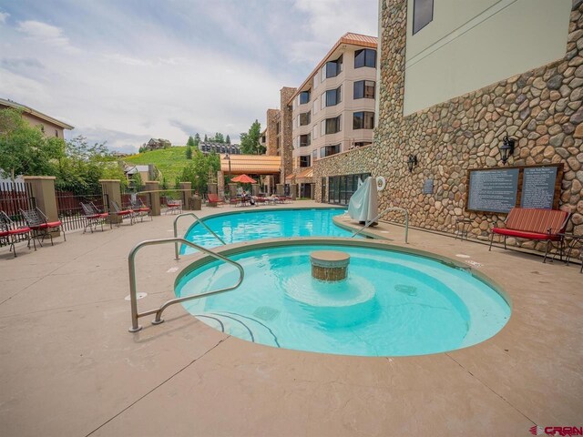 view of swimming pool with a patio