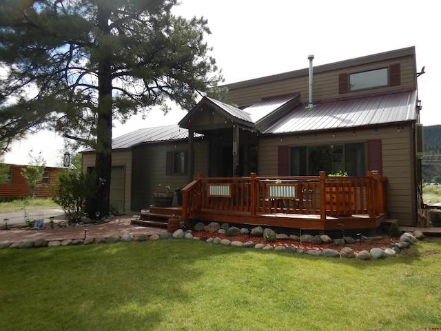 back of house featuring a wooden deck and a lawn