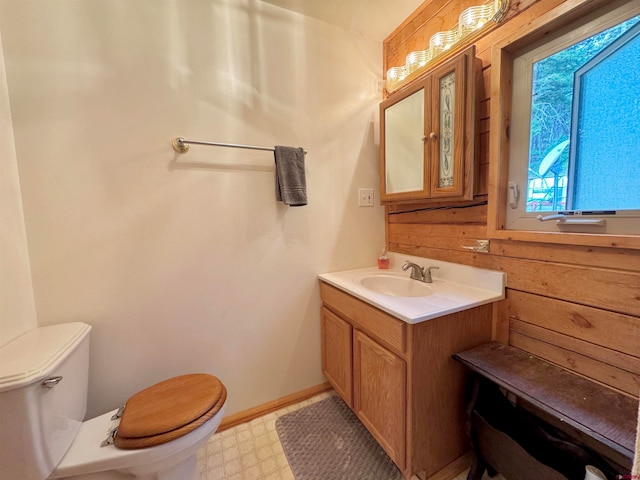 bathroom with toilet, tile patterned floors, and vanity