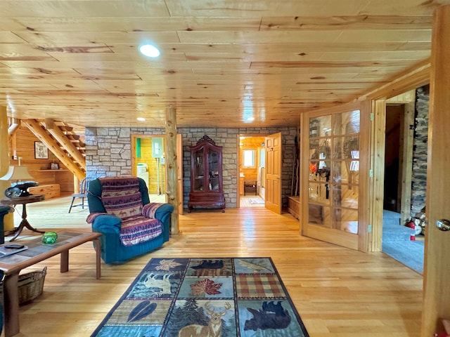 unfurnished living room featuring light hardwood / wood-style flooring, log walls, and wood ceiling