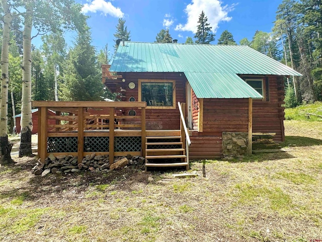 back of house featuring a wooden deck