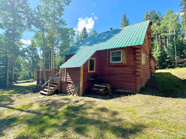 view of home's exterior featuring a deck and a yard