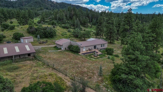 birds eye view of property with a view of trees