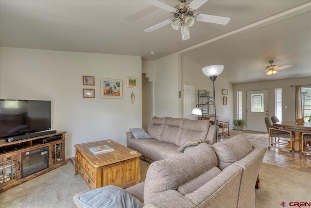 living area featuring light colored carpet and ceiling fan