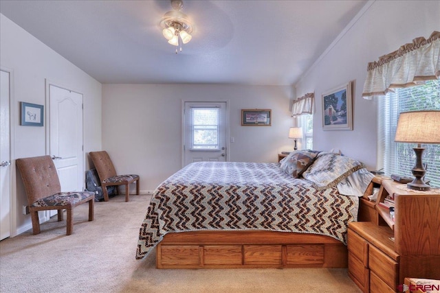 bedroom featuring ceiling fan, vaulted ceiling, and light colored carpet