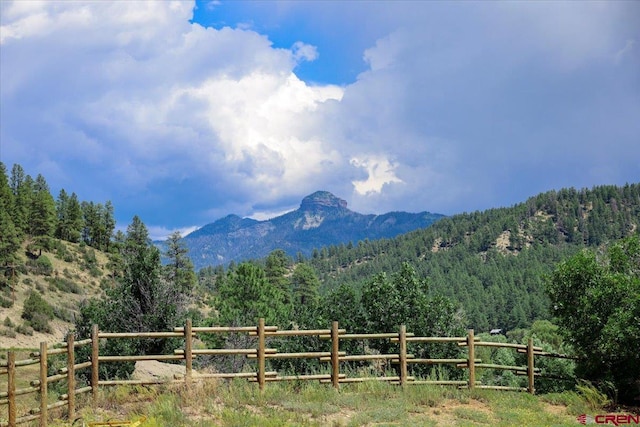 property view of mountains featuring a rural view and a wooded view