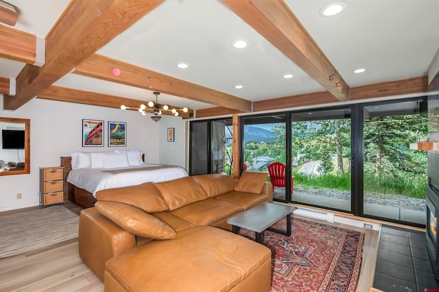 bedroom featuring beam ceiling, an inviting chandelier, access to outside, and light hardwood / wood-style flooring