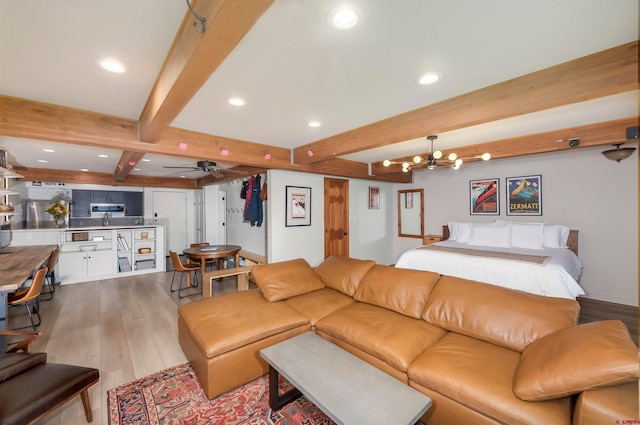 living room with ceiling fan, beam ceiling, and light wood-type flooring