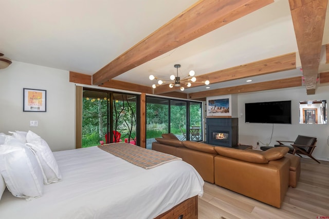 bedroom featuring beam ceiling, light hardwood / wood-style flooring, access to outside, and a notable chandelier