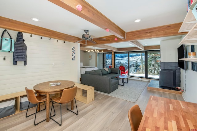 dining space featuring beamed ceiling, light hardwood / wood-style floors, and ceiling fan