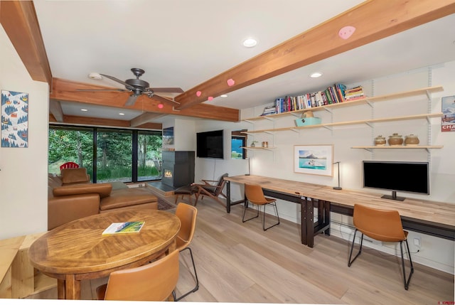 living room featuring ceiling fan, built in desk, beamed ceiling, and light hardwood / wood-style floors