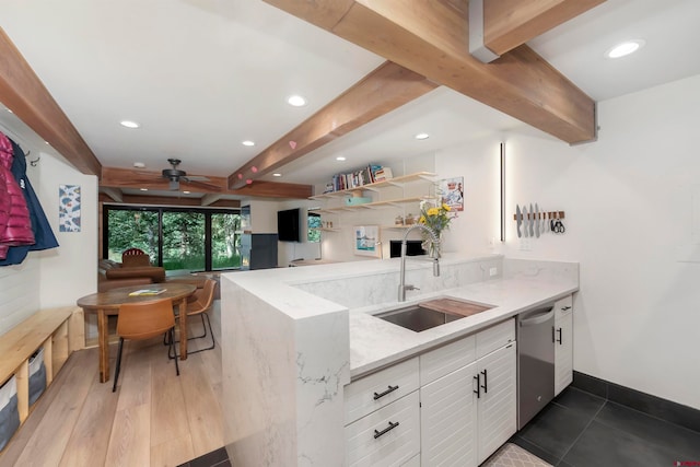 kitchen with dishwasher, sink, light stone counters, white cabinets, and light wood-type flooring