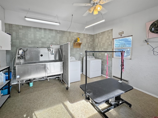 miscellaneous room featuring washer and dryer, tile walls, and tile patterned floors