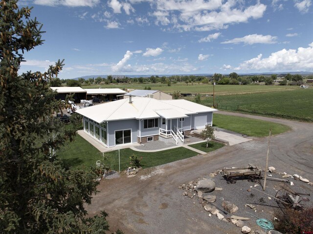 view of front of house with a front lawn and an outdoor structure