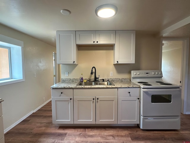 kitchen featuring white electric range, dark hardwood / wood-style flooring, sink, and white cabinets