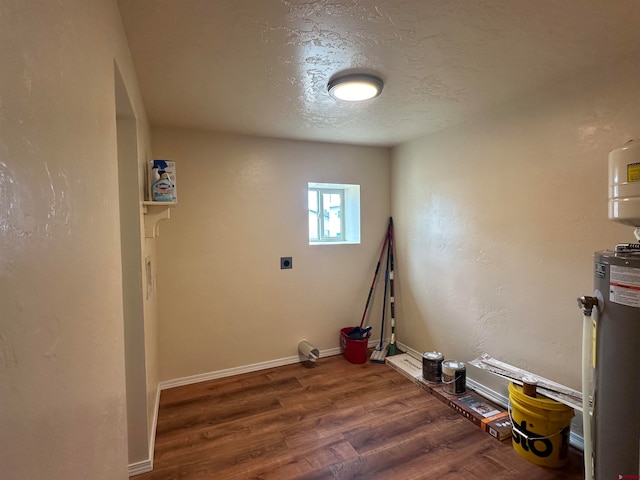 interior space featuring water heater, hookup for an electric dryer, a textured ceiling, and hardwood / wood-style floors