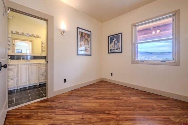 unfurnished bedroom with sink and dark tile patterned flooring