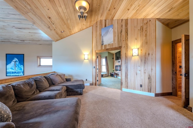 carpeted living room with high vaulted ceiling, wooden walls, and wood ceiling